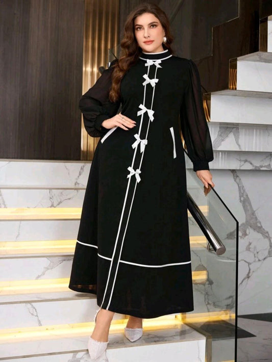 فستان أسود مزين بالأبيض طويل أنيق بأكمام شفافة ومنفوخة و خصر مشدود مقاسات كبيرة